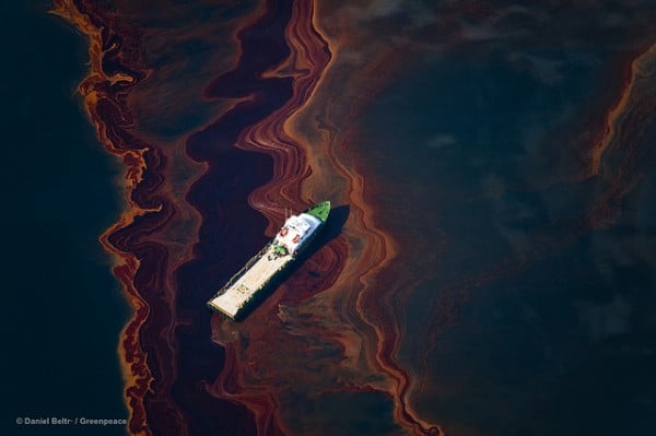 A view from an altitude of 3200 ft of the oil on the sea surface, originated by the leaking of the Deepwater Horizon wellhead disaster. The BP leased oil platform exploded April 20 and sank after burning, leaking an estimate of more than 200,000 gallons of crude oil per day from the broken pipeline into the sea.