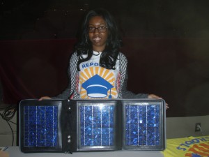 Kearra, a student at Southern High for Energy & Sustainability in Durham, holds up solar a demonstration solar panel to other students