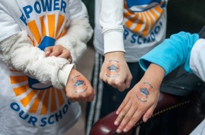 Kids show off their temporary tattoos with the Repower Our Schools logo!