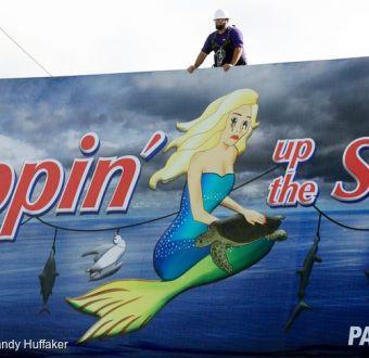 Workers install Chicken of the Sea protest billboard