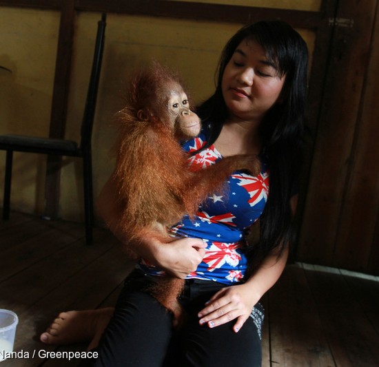 22-year-old Ayu Nurisaputra holds eight-month-old Otan.