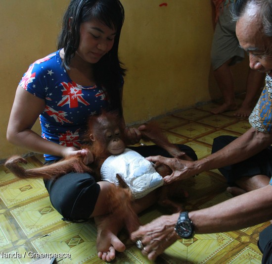 Ayu and her father-in-law play with baby Otan.