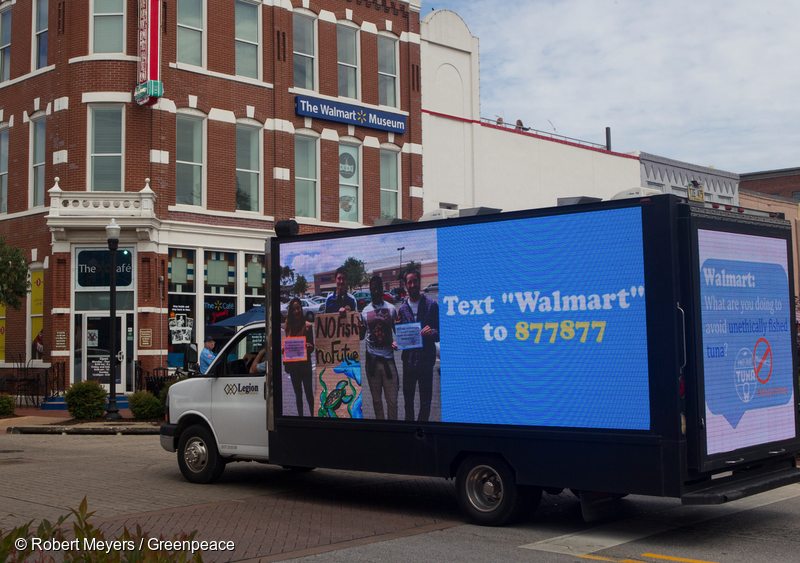 A video truck displays information about ocean destruction associated with Walmart canned tuna near their world headquarters.