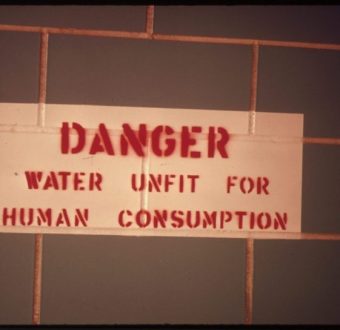 Sign in a restroom along Interstate 25 south of Colorado Springs, Colorado, warns that water is undrinkable, April 1974