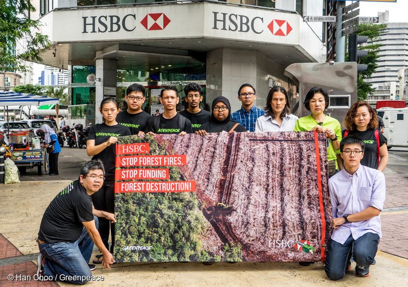 Greenpeace activists carry a banner as they deliver a petition to HSBC Headquarter in Kuala Lumpur. More than 220,000 people globally signed the petition urging HSBC to stop funding six palm oil corporations that destroy the rainforest and peat land in Indonesia.