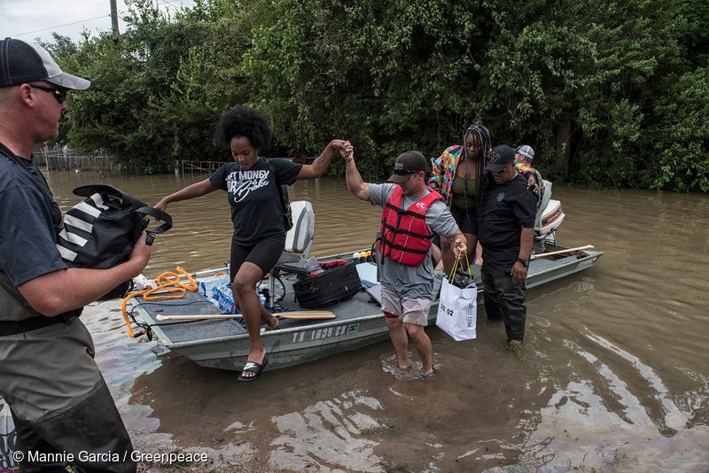 People with their personal boat help rescue residents from flooded neighborhoods near Katy, Texas.