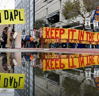 People carry signs in support of the Standing Rock Nation at the City Center Plaza of San Francisco. The protest was one of many in a global day of action against the Dakota Access Pipeline (DAPL) calling on the U.S. Army Corps of Engineers to cancel the permit for the project.