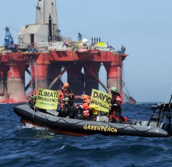 Greenpeace activists in an inflatable boat display banners on day 10 of the BP rig protest in the North Sea.