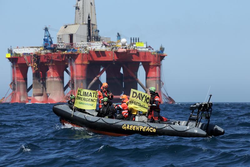 Greenpeace activists in an inflatable boat display banners on day 10 of the BP rig protest in the North Sea.
