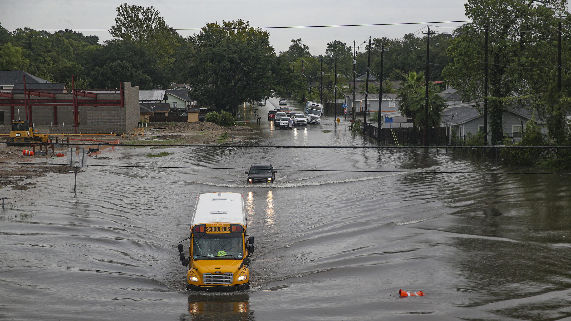 A school bus makes its way through a flooded road in Houston